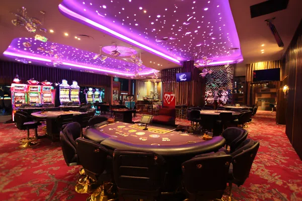 2777BET6 Mobile App — Your complete hub for casino and sports A man focused on his laptop with live stats in the background, highlighting the dedicated sports and gaming features of the 2777BET6 mobile app.